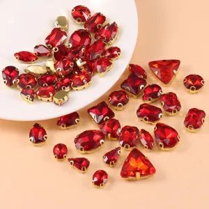 Assorted red glass crystal rhinestones with gold settings for DIY craft dress accessories.