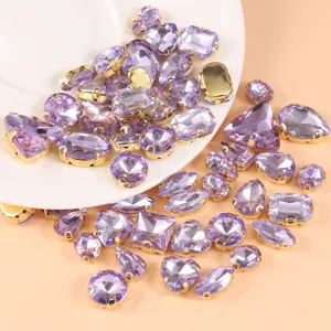Mixed crystal glass sew-on rhinestones with gold settings for DIY crafts and wedding dresses.