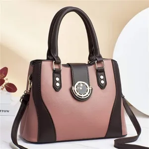 Detailed view of the pink and brown contrast handbag featuring premium textured leather material.
