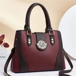 Close-up detail of the stylish maroon and brown leather handbag with golden hardware deco.
