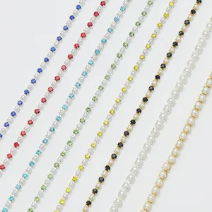 Close-up detail of colorful rhinestone and pearl cup chains for DIY apparel and crafts decoration.