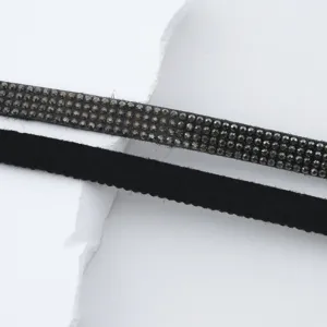 Rhinestone trim and black suede cord detail shot, perfect for DIY garment and craft design.