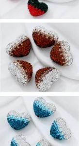 Detail shot of gradient rhinestone heart charms, sparkling crystal beads for DIY jewelry making.
