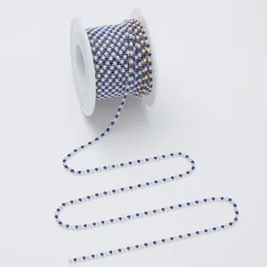 Detailed view of pearl and blue rhinestone cup chain, perfect for DIY garments and crafts.