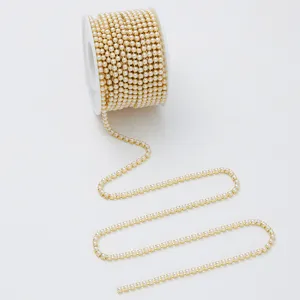 Close-up detail of gold-tone pearl claw chain trim for DIY crafting and phone case decor.