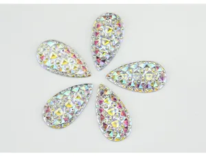Teardrop resin rhinestones close-up, shiny flatback crystal gems for DIY craft accessories.
