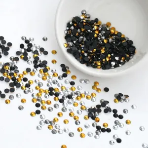 Mixed color resin flatback rhinestones for DIY crafts, sparkling crystal beads in a bowl.