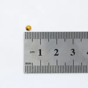 Resin flatback rhinestone detail shot, gold crystal diamond for DIY garment dress crafting.