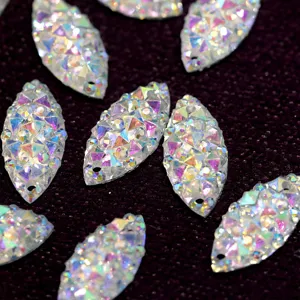 Close-up detail of iridescent marquise resin rhinestones with dual holes for DIY crafts.