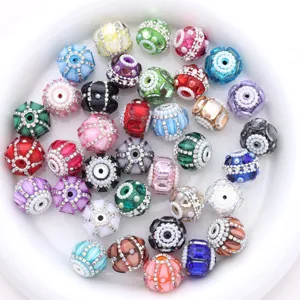 Detailed view of colorful glass beads with rhinestones, perfect for DIY jewelry making.
