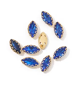 Close-up view of navy blue marquise claw rhinestones with gold lace setting for DIY crafts.