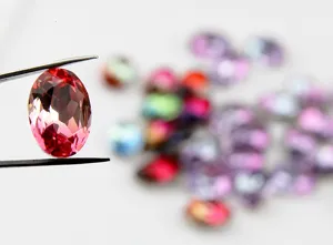 Close-up detail of 13x18mm oval faceted pink synthetic tourmaline rhinestone DIY jewelry accessory.
