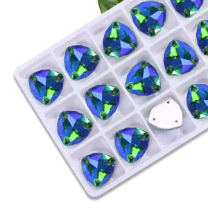 Detailed view of fat triangle sew-on rhinestones in a white tray, AB glass crystals for DIY.