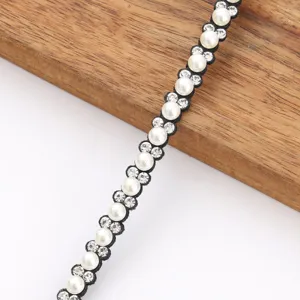 Rhinestone pearl felt trim detail showing sparkly DIY clothing accessory ribbon edging close up.