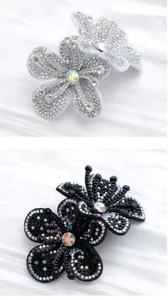 Close-up of sparkling rhinestone flower shoe clips with detailed crystal craftsmanship.