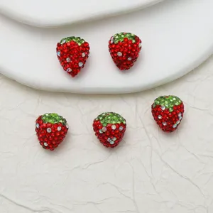 Close-up detail of sparkling strawberry rhinestone clay loose beads for DIY jewelry making.