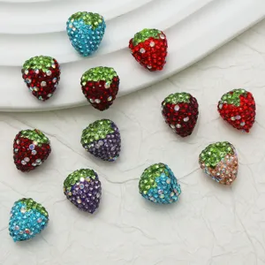 Detailed close-up of colorful rhinestone strawberry beads for DIY jewelry and crafts making.