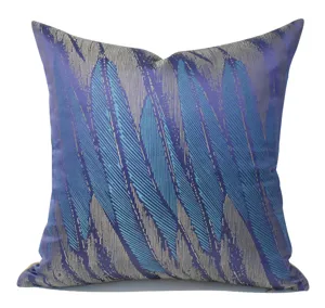 Close-up detail of luxury purple and blue abstract feather pattern cushion fabric texture.