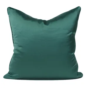 Close-up detail of smooth green decorative pillow cover showing fabric texture and fine stitching.