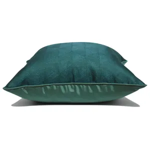 Dark green geometric throw pillow cover detail showing premium woven texture and neat piping edge.