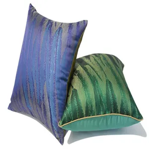 Detailed view of luxury feather pattern decorative throw pillows in vibrant blue and green colors.