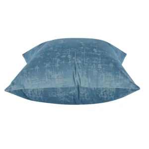 Close-up detail of blue plush abstract textured throw pillow cover, soft velvet fabric.