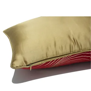 Detailed shot of a luxury rectangular lumbar pillow cover with gold satin and red striped design.