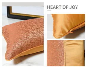 Close-up detail of modern luxury orange abstract long throw pillow, showing zipper and fabric.