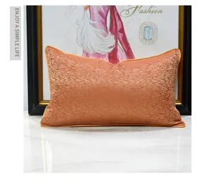 Orange abstract throw pillow detail view, modern luxury sofa cushion with refined edge piping.