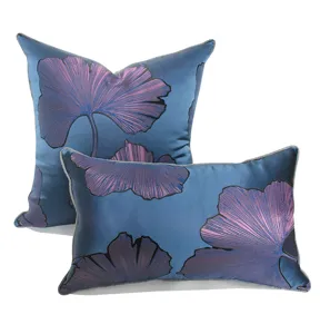 Detailed close-up of blue and purple ginkgo leaf throw pillow covers, luxury living room set.