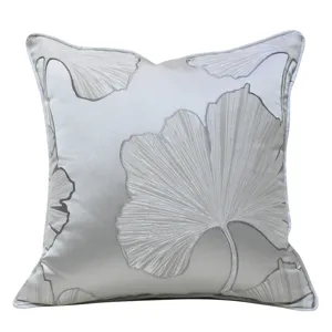 Modern minimalist grey square throw pillow cover with elegant large ginkgo leaf pattern for home sofa.