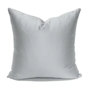 Detail view of the silver grey cushion cover, showing the smooth fabric texture and plump shape.