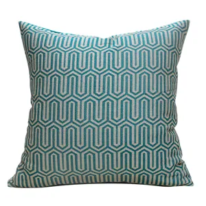Housse de coussin décorative géométrique moderne turquoise et grise pour canapé de salon.