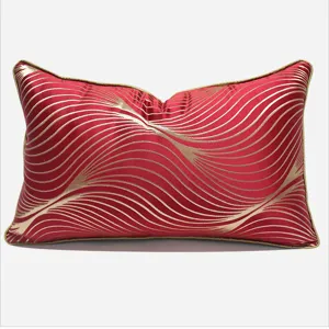 Modern red rectangular throw pillow with gold wavy pattern and piping for luxury sofa home decor.