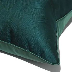 Luxurious dark green velvet throw pillow cover with geometric triangle pattern for sofa.