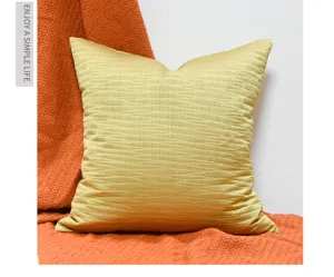 Gold jacquard throw pillow detail, textured square cushion cover for modern home decor.