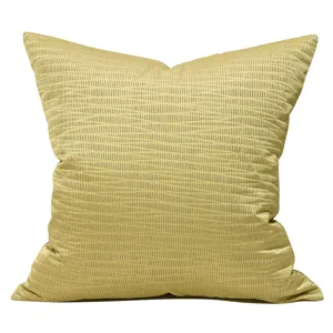 Golden square throw pillow featuring geometric jacquard texture for sofa and home decor.
