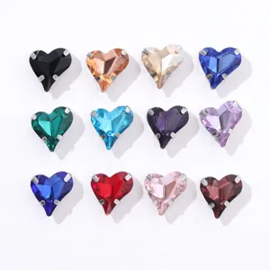 Close-up of colorful heart-shaped crystal rhinestones with silver claw settings for DIY crafts.