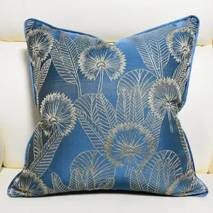 Detail view of New Chinese blue throw pillow cover with elegant gold botanical embroidery.