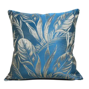 Blue jacquard throw pillow cover with tropical botanical leaf design for sofa and home decor.