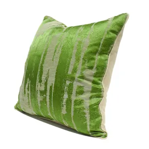 Detail view of green abstract decorative throw pillow cover showing soft fabric texture and edge.