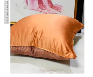 Modern luxury orange satin throw pillow cover with geometric pattern for living room sofa.