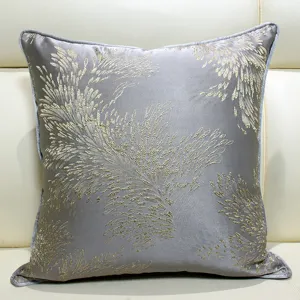 Grey jacquard throw pillow cover with gold floral pattern for modern living room decor.