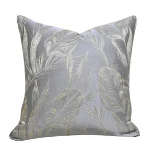 Luxurious jacquard throw pillow cover with golden leaf botanical pattern for home decoration.