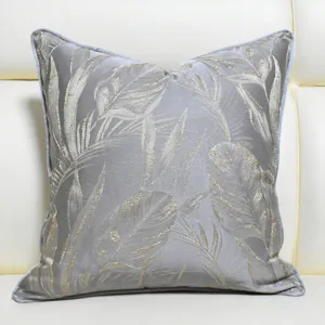 Luxury jacquard throw pillow cover with golden tropical leaf design for modern sofa decor.