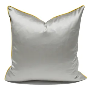 Modern square throw pillow cover in sleek grey fabric with vibrant yellow piping details.