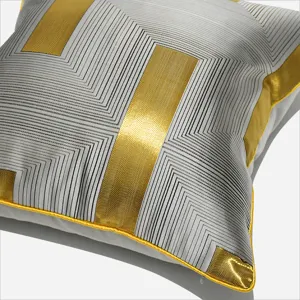 Modern luxury gray square throw pillow cover with metallic gold and black geometric stripes.