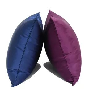 Solid color satin throw pillow cover detail view, modern soft furnishing cushion accessory.