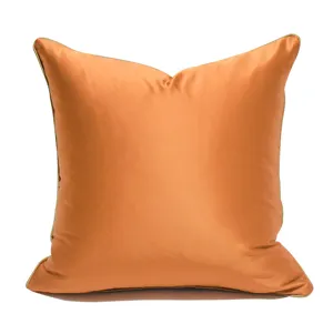 Orange gold satin throw pillow cover close-up, smooth soft fabric detail for modern home decor.
