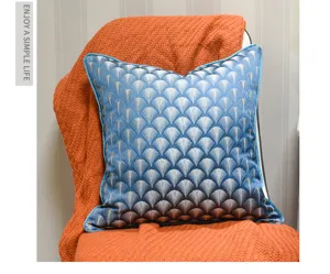 Detail view of the elegant blue fan patterned throw pillow with blue piping and soft texture.
